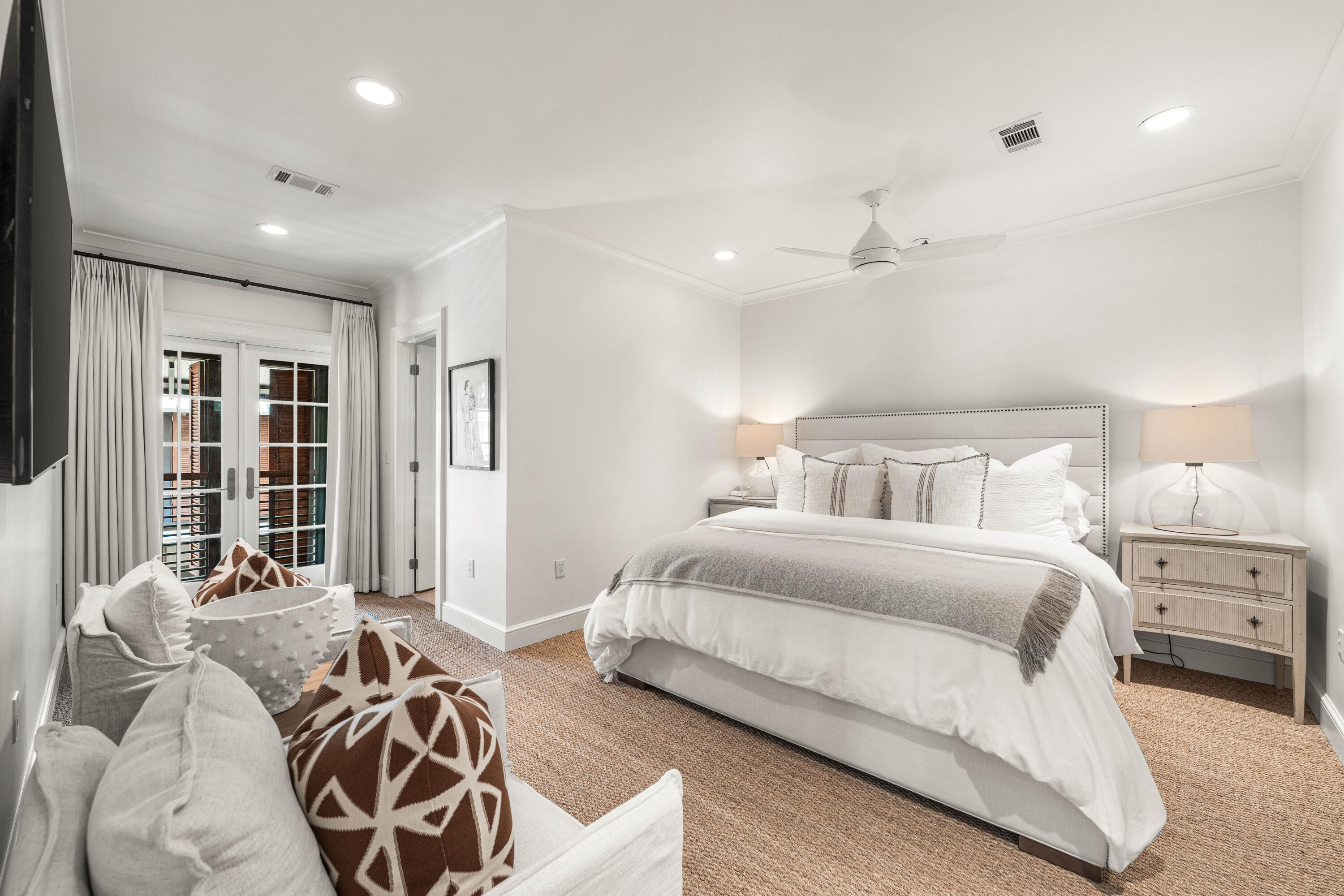 249 Lifeguard Loop East, Unit A3 Inlet Beach, FL 32461 - Photo 34 of 60 a spacious bedroom with a bed a couch and a chandelier