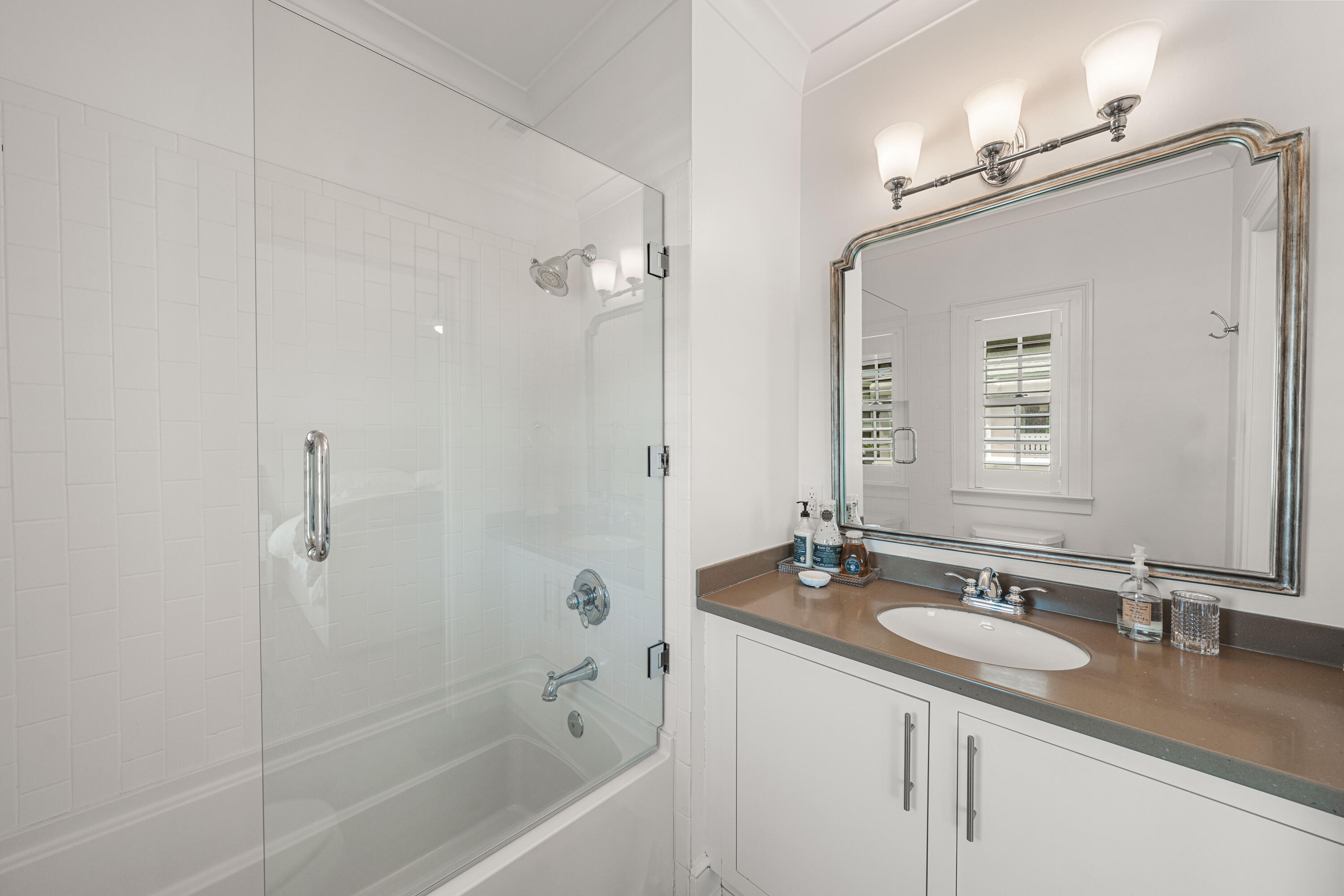 249 Lifeguard Loop East, Unit A3 Inlet Beach, FL 32461 - Photo 42 of 60 a bathroom with a granite countertop sink mirror and a bathtub