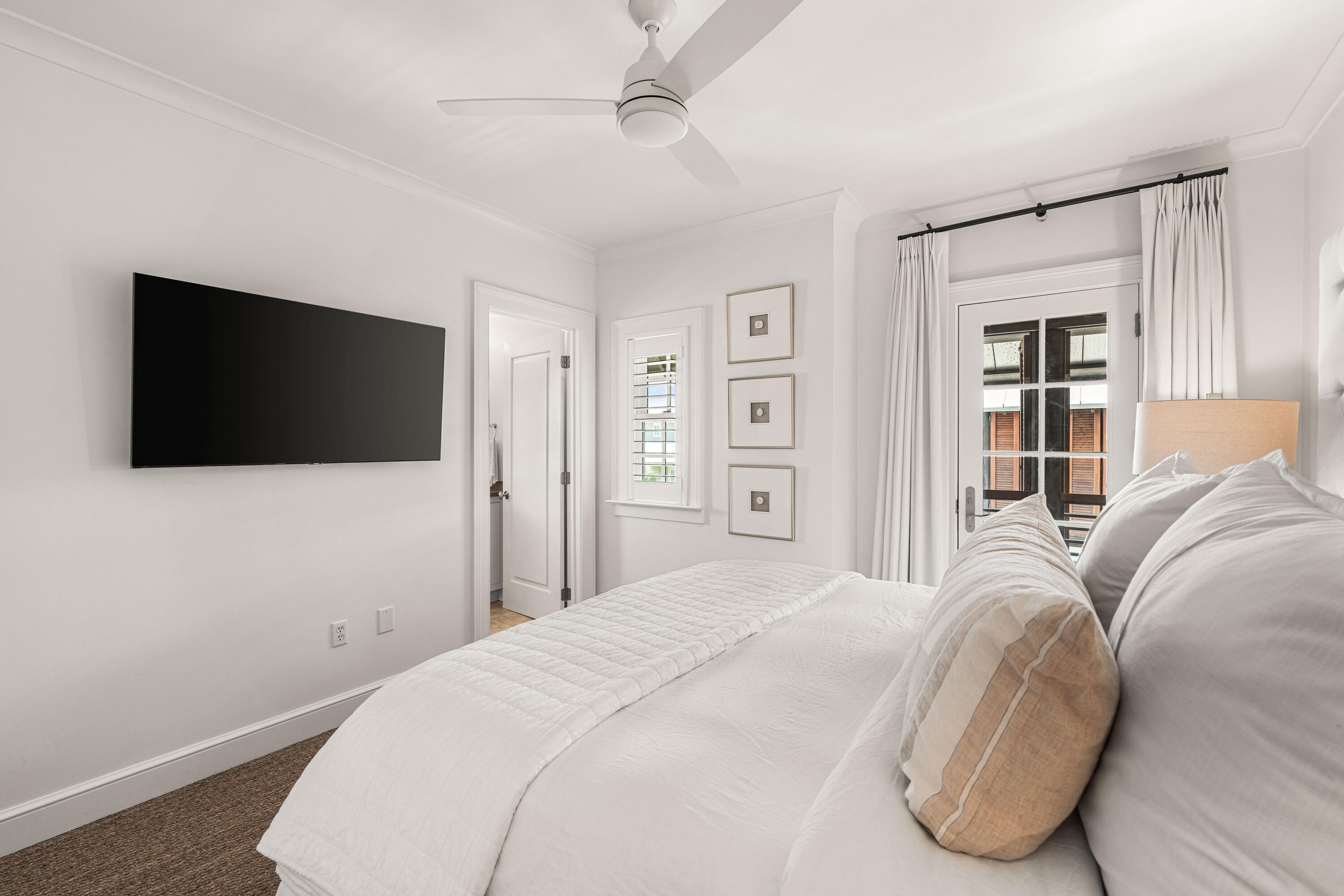 249 Lifeguard Loop East, Unit A3 Inlet Beach, FL 32461 - Photo 43 of 60 a bedroom with a bed and a flat screen tv