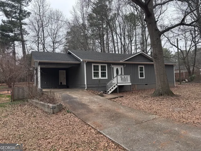 a view of a yard with a house and a large tree