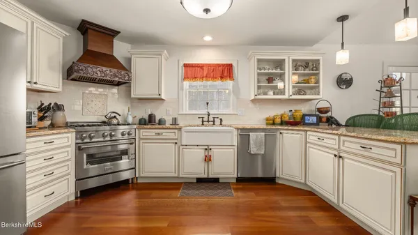 a kitchen with white cabinets and white appliances