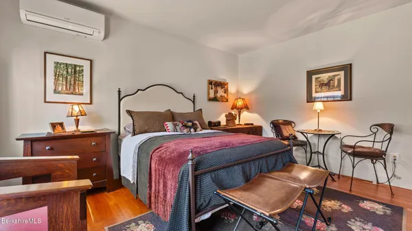 a bedroom with a bed and wooden furniture