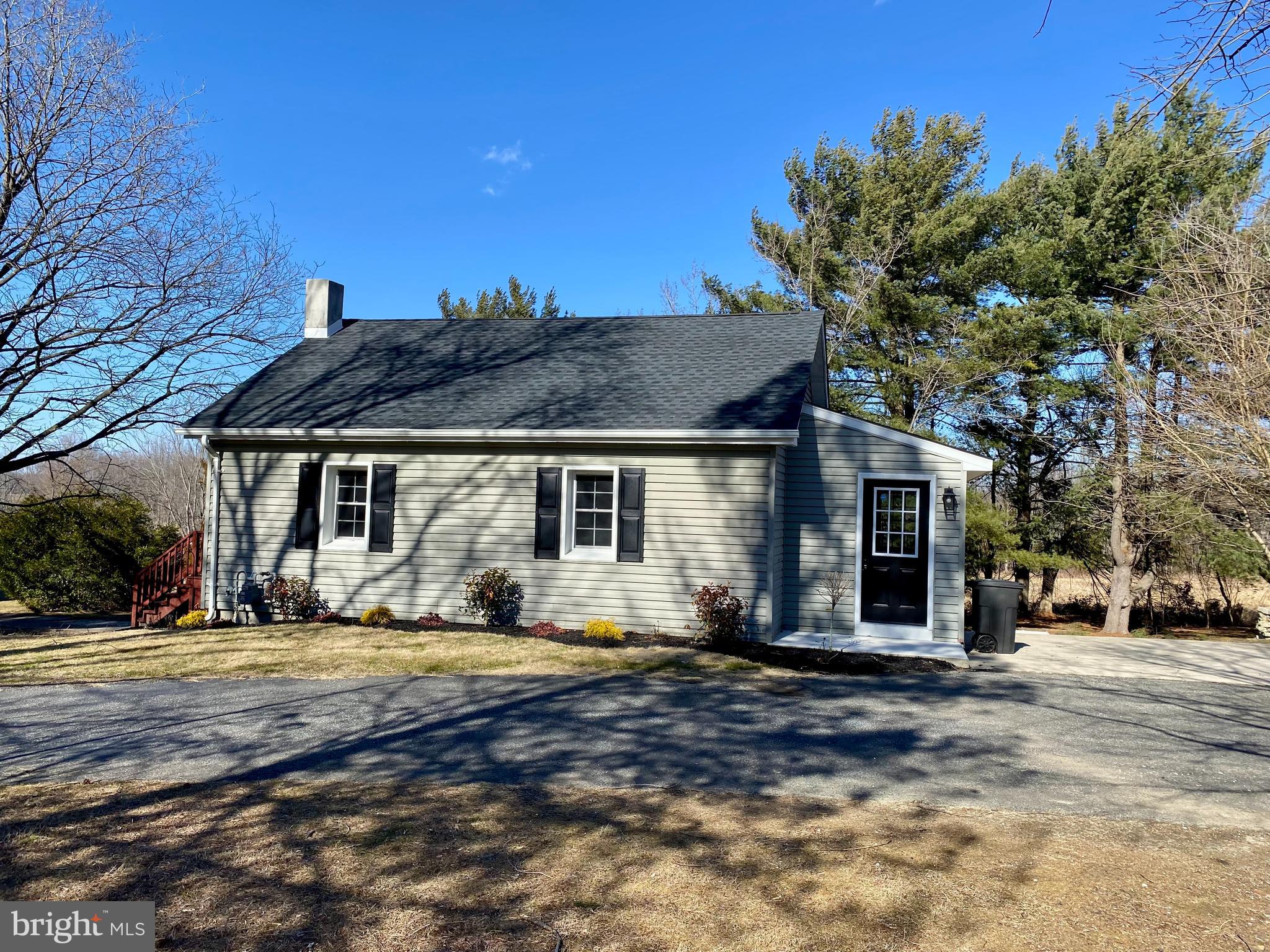 1297 Highway 40 Pilesgrove, NJ 08098 - Photo 1 of 32 a front view of house with yard and trees in the background