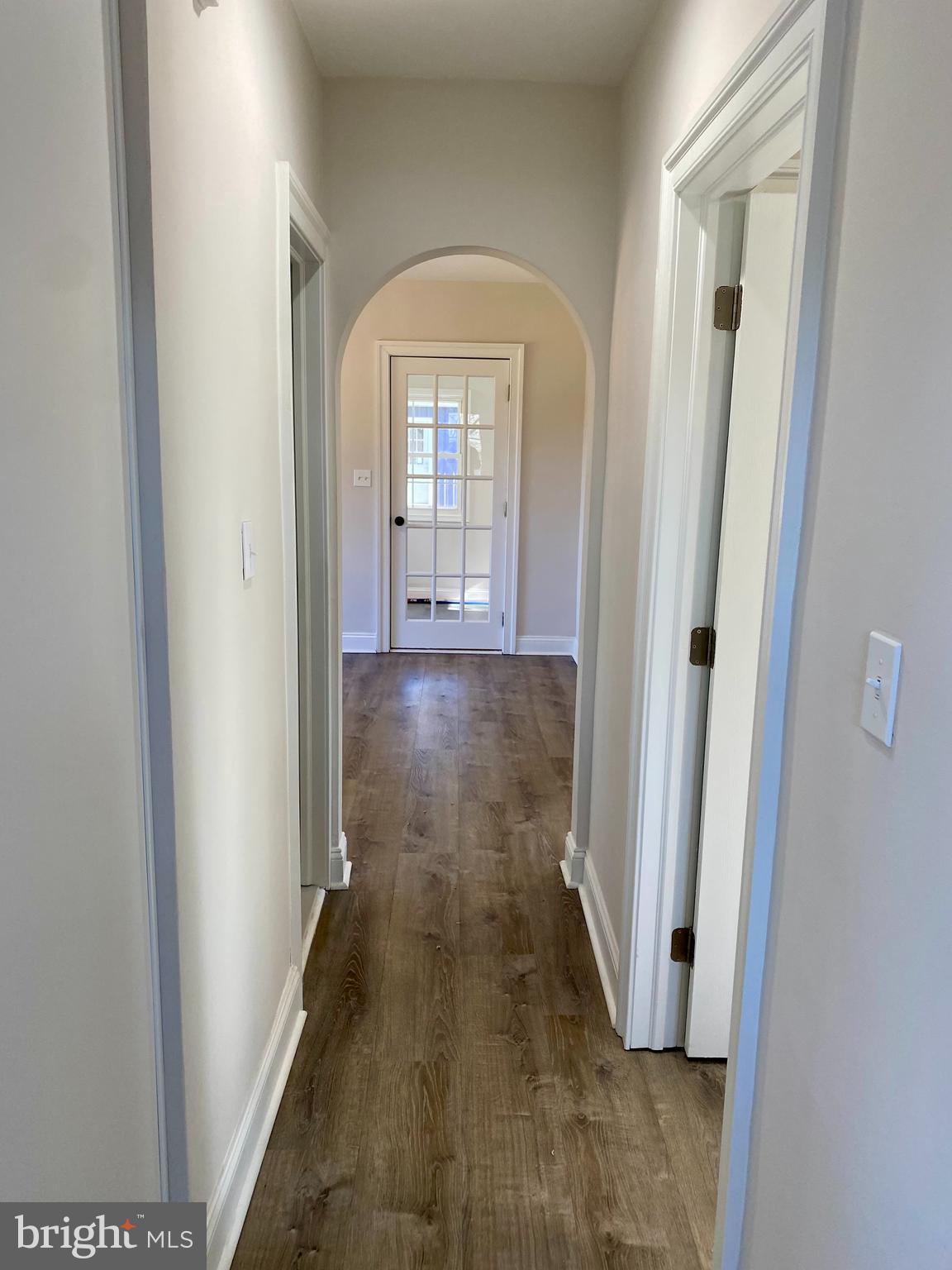 1297 Highway 40 Pilesgrove, NJ 08098 - Photo 12 of 32 a view of a hallway with wooden floor and a living room