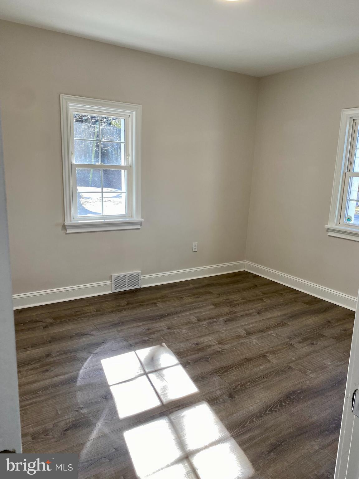 1297 Highway 40 Pilesgrove, NJ 08098 - Photo 18 of 32 a view of empty room with wooden floor and fan