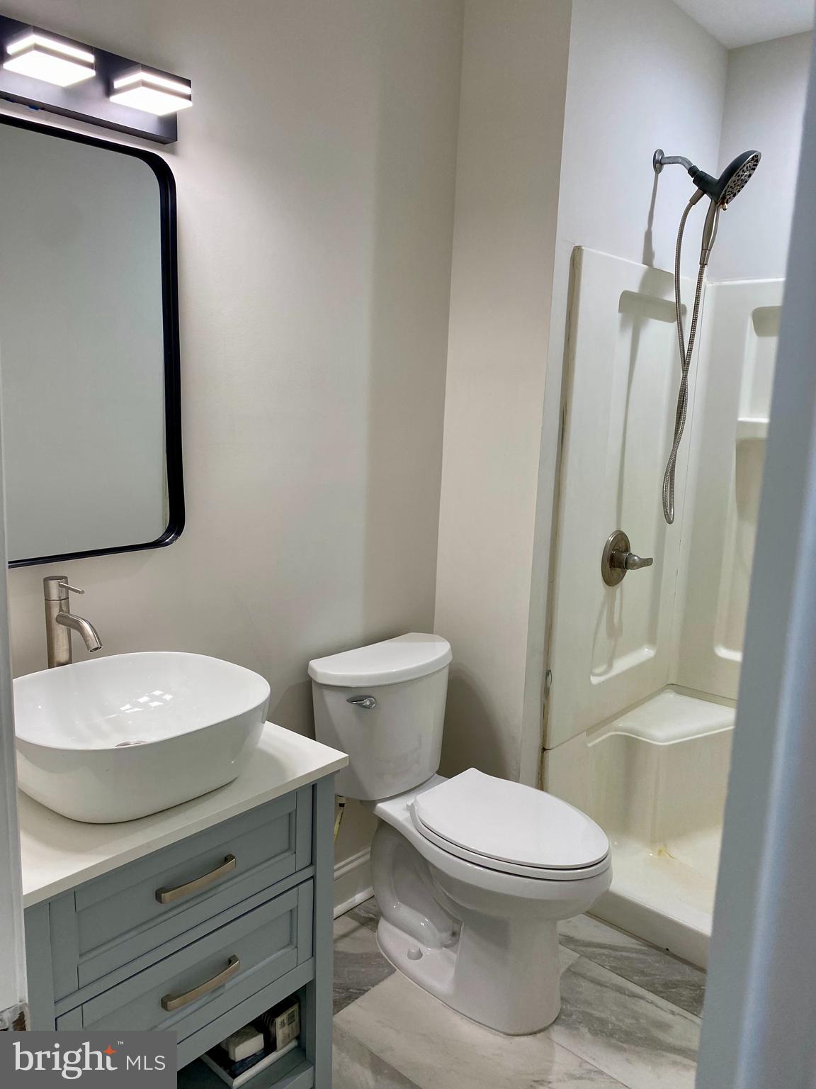 1297 Highway 40 Pilesgrove, NJ 08098 - Photo 20 of 32 a bathroom with a sink a toilet and shower