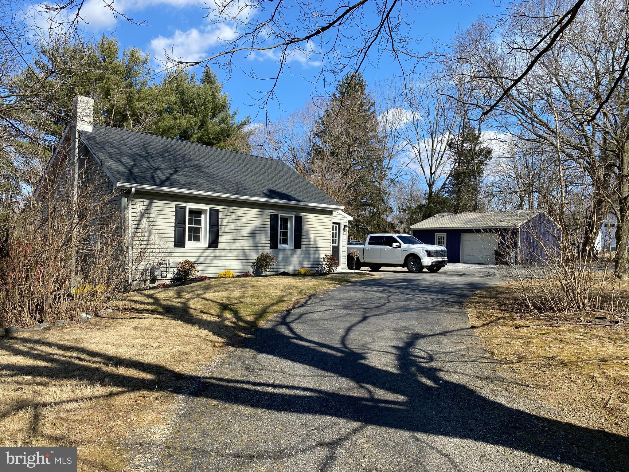 1297 Highway 40 Pilesgrove, NJ 08098 - Photo 2 of 32 a front view of a house with garden