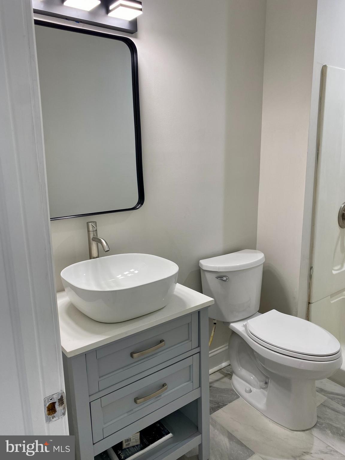 1297 Highway 40 Pilesgrove, NJ 08098 - Photo 21 of 32 a bathroom with a toilet and a sink