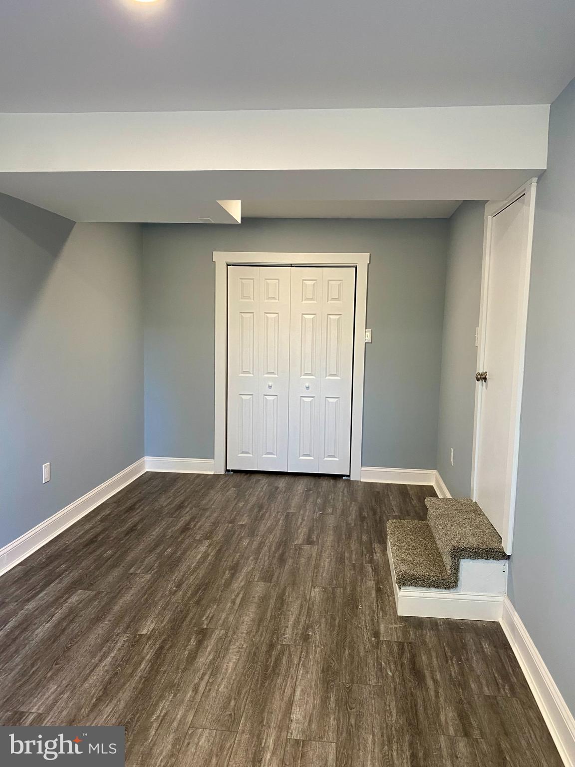1297 Highway 40 Pilesgrove, NJ 08098 - Photo 25 of 32 an empty room with wooden floor and windows