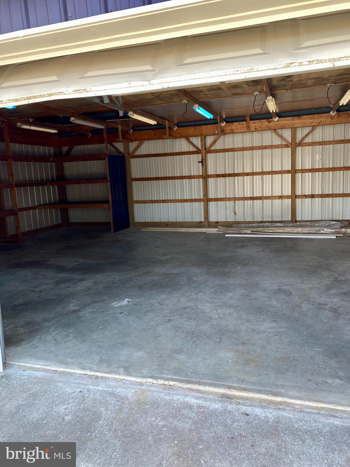 1297 Highway 40 Pilesgrove, NJ 08098 - Photo 30 of 32 a view of a garage with racks on the wall