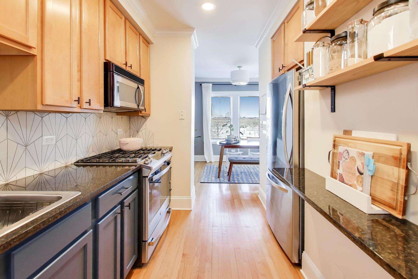 1424 West Cullom Avenue, Unit 3 Chicago, IL 60613 - Photo 11 of 18 a kitchen with stainless steel appliances granite countertop a stove and a refrigerator