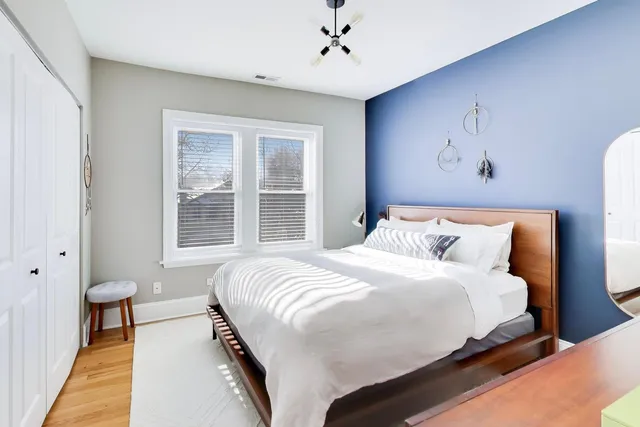 a bedroom with a large bed and a chandelier