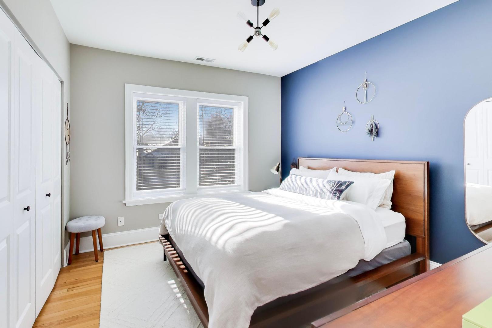 1424 West Cullom Avenue, Unit 3 Chicago, IL 60613 - Photo 12 of 18 a bedroom with a large bed and a chandelier