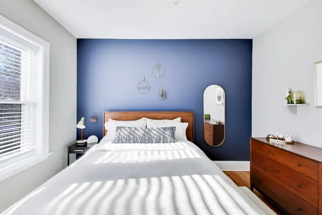 a bed room with a bed and a window