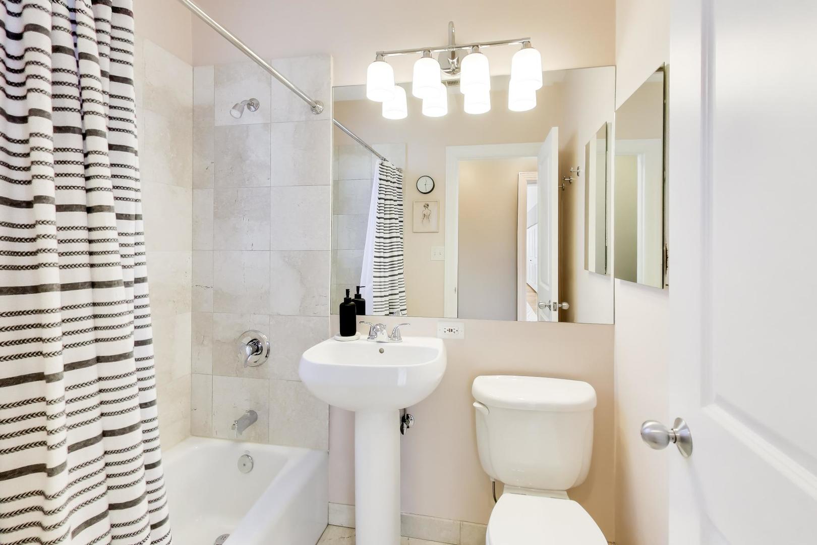 1424 West Cullom Avenue, Unit 3 Chicago, IL 60613 - Photo 15 of 18 a bathroom with a sink toilet and shower