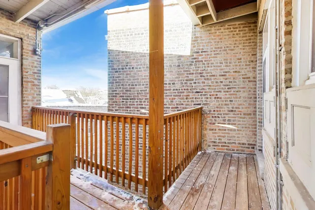a view of a balcony with wooden floor