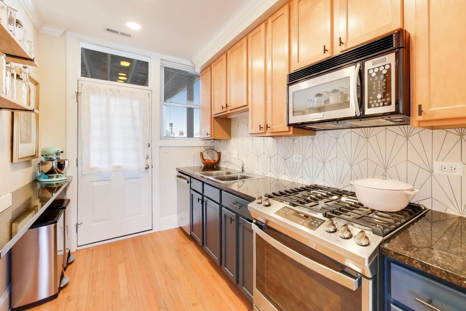 1424 West Cullom Avenue, Unit 3 Chicago, IL 60613 - Photo 10 of 18 a kitchen with a stove and a microwave