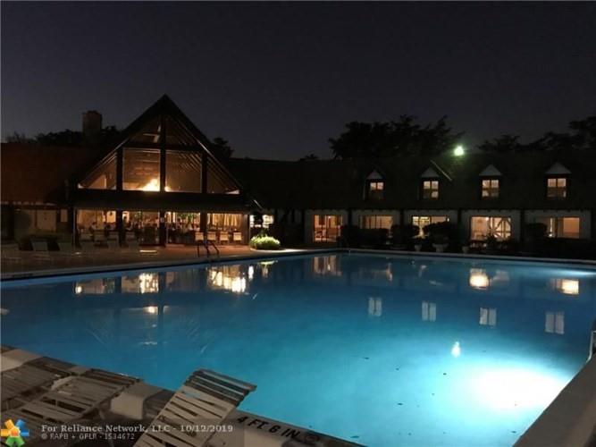 3660 Inverrary Drive, Unit 1B Lauderhill, FL 33319 - Photo 2 of 5 a view of a swimming pool with seating area