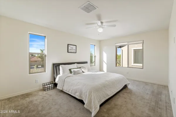 a bedroom with a bed and a window