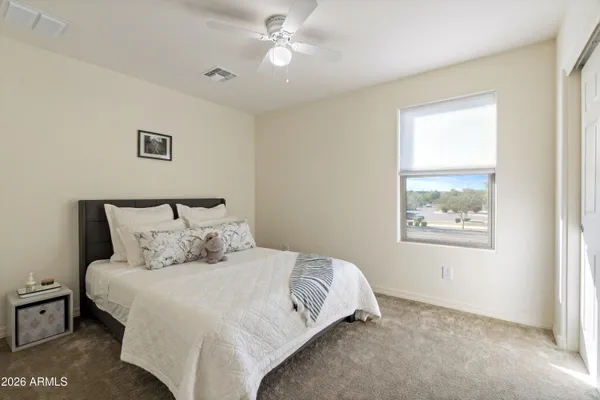 a large bed sitting in a bedroom next to a window