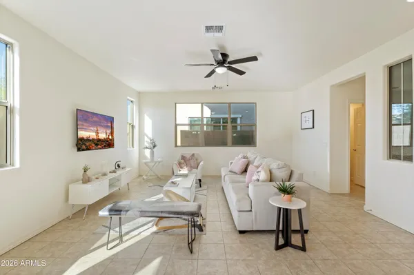 a living room with furniture a window and a flat screen tv