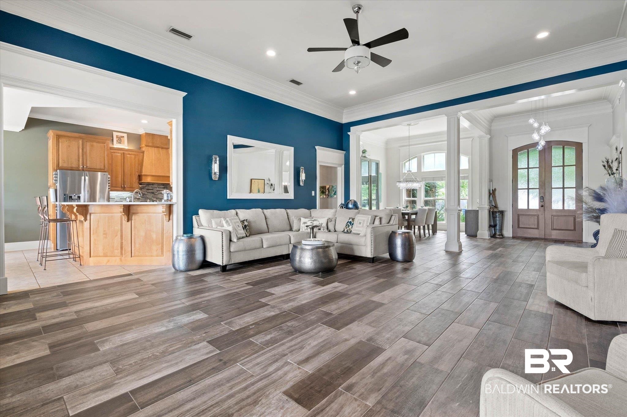 24908 Bosbyshell Avenue Daphne, AL 36526 - Photo 25 of 49 Spacious living area featuring wood-finish flooring, a ceiling fan, and prominent white crown molding