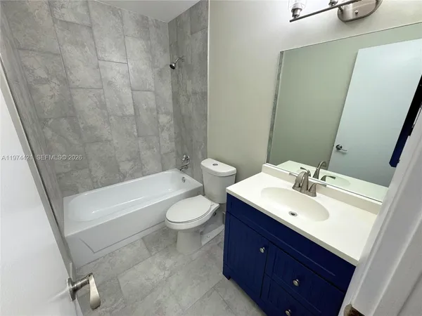 a bathroom with a sink a toilet and bathtub