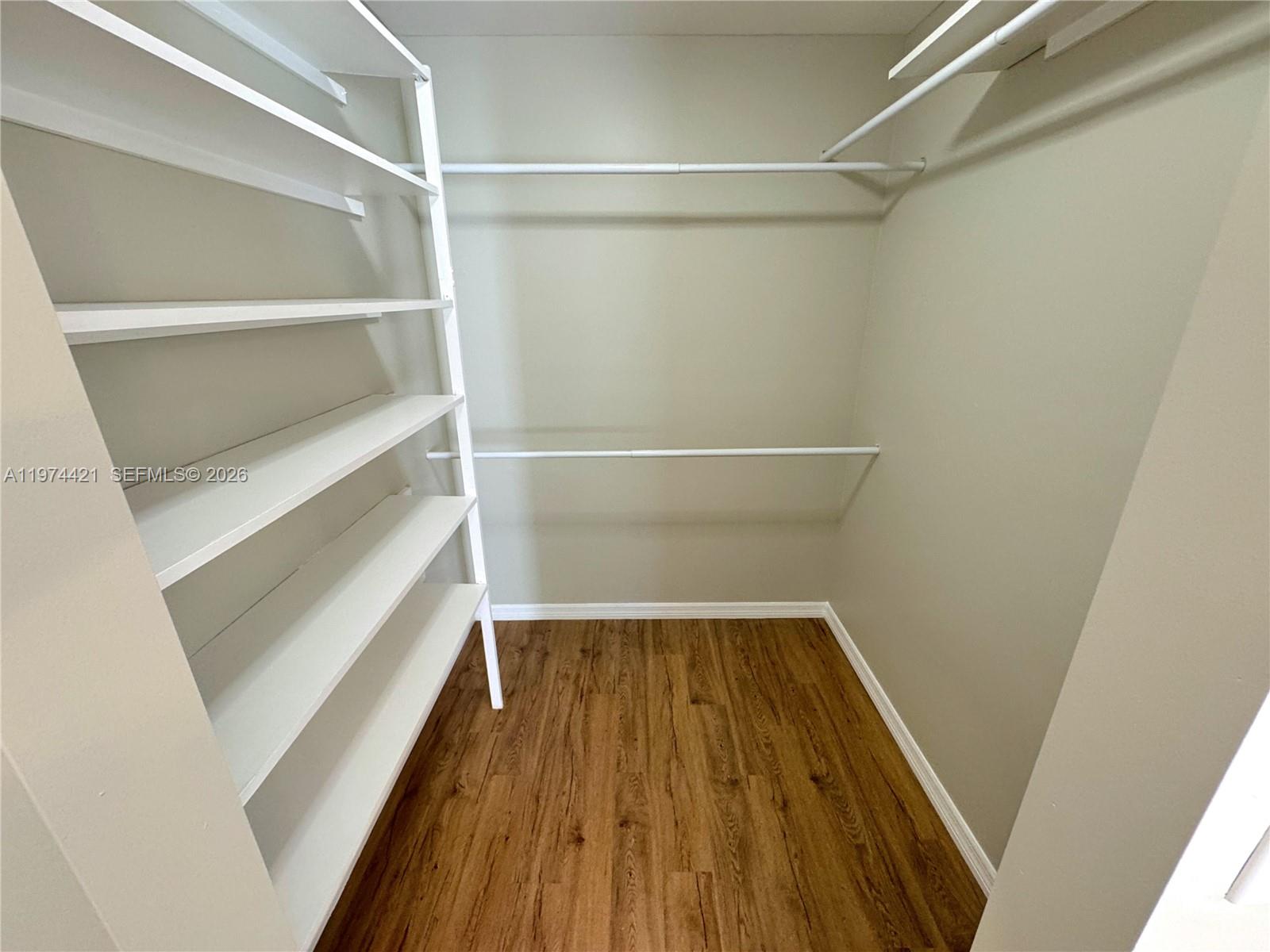 22278 Misty Woods Way Boca Raton, FL 33428 - Photo 13 of 20 a view of walk in closet with wooden floor
