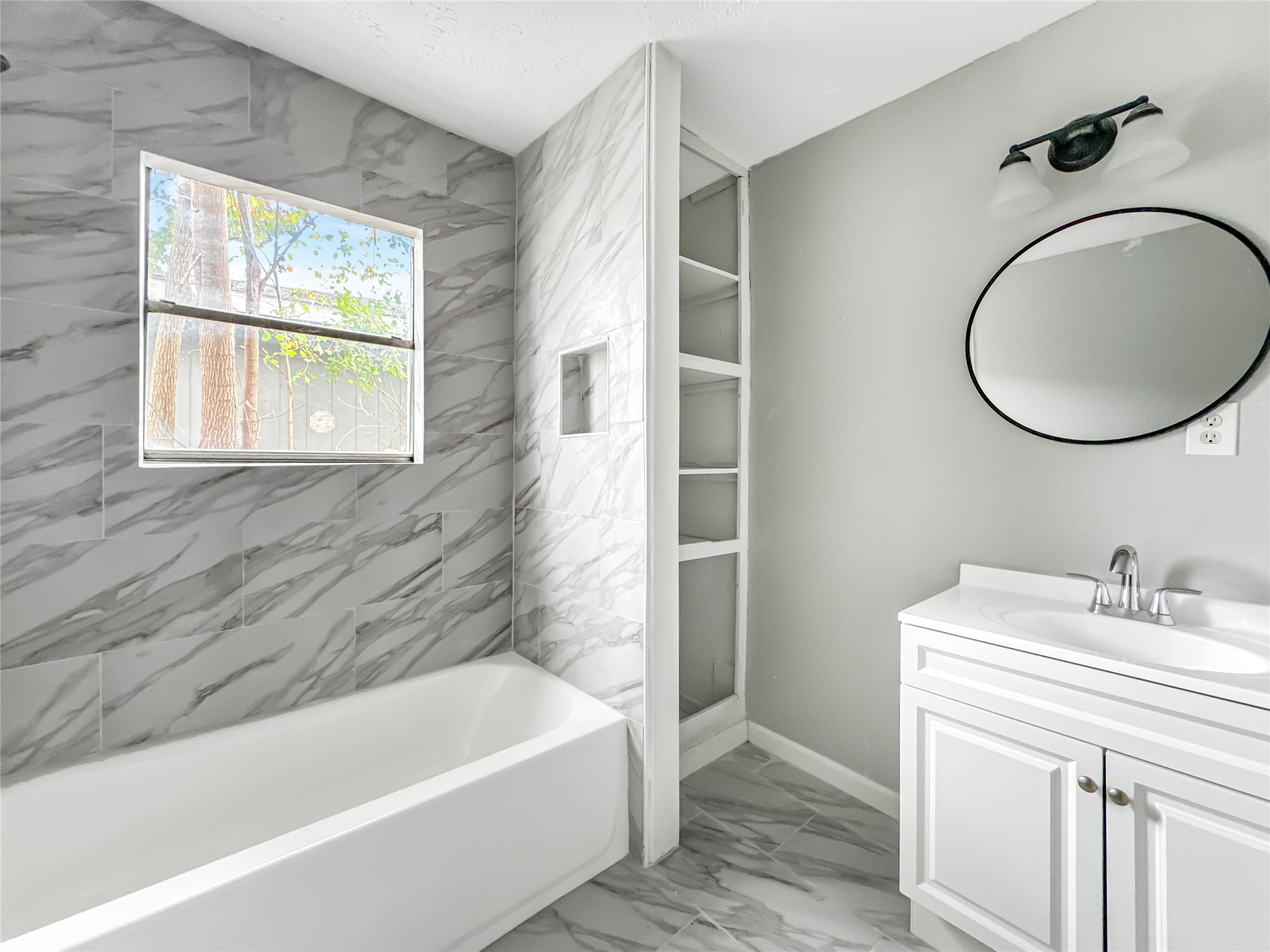 306 Armstrong Street Houston, TX 77029 - Photo 24 of 30 a bathroom with a sink a bathtub and a window