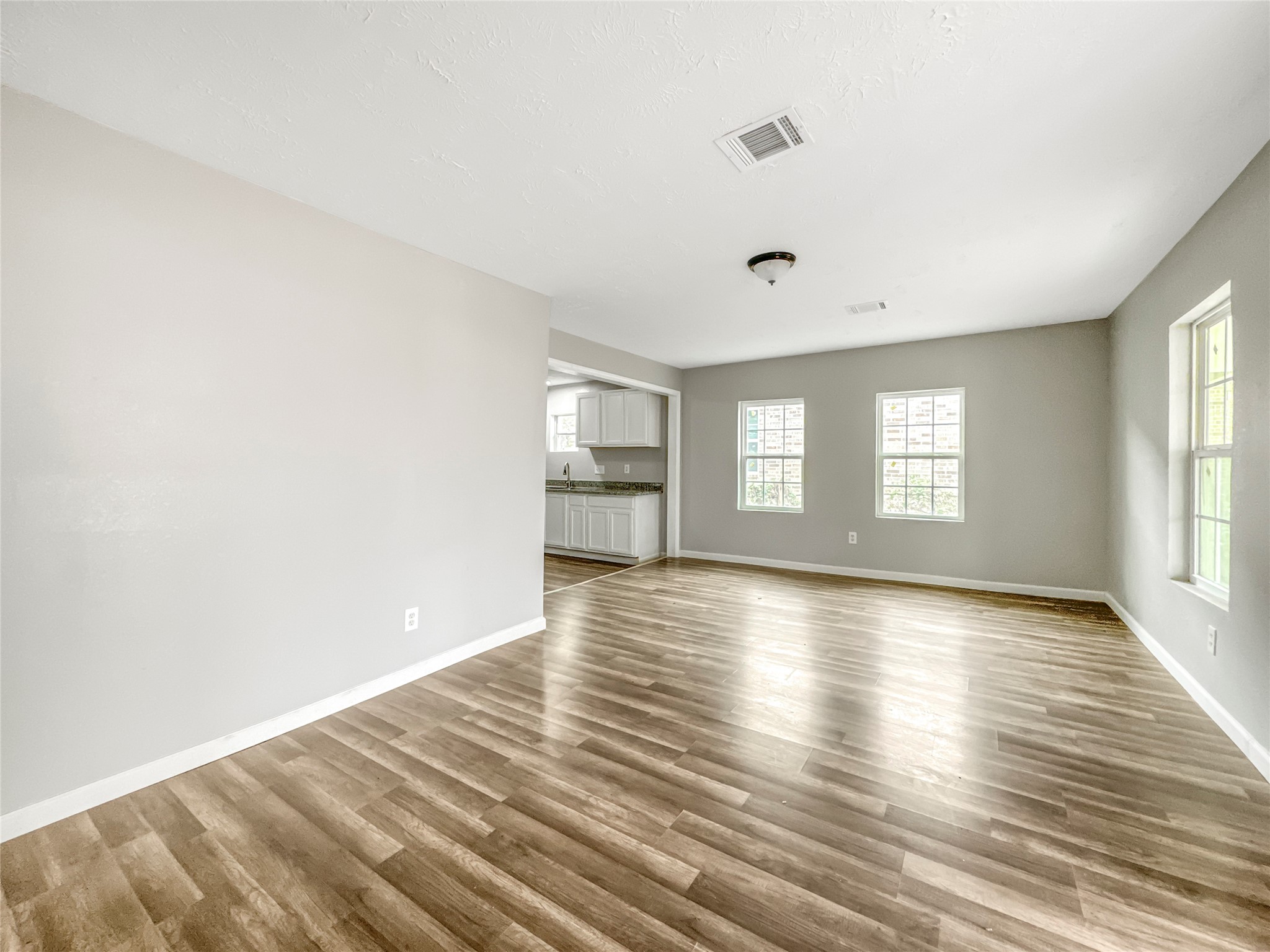 306 Armstrong Street Houston, TX 77029 - Photo 4 of 30 a view of empty room with wooden floor and fan