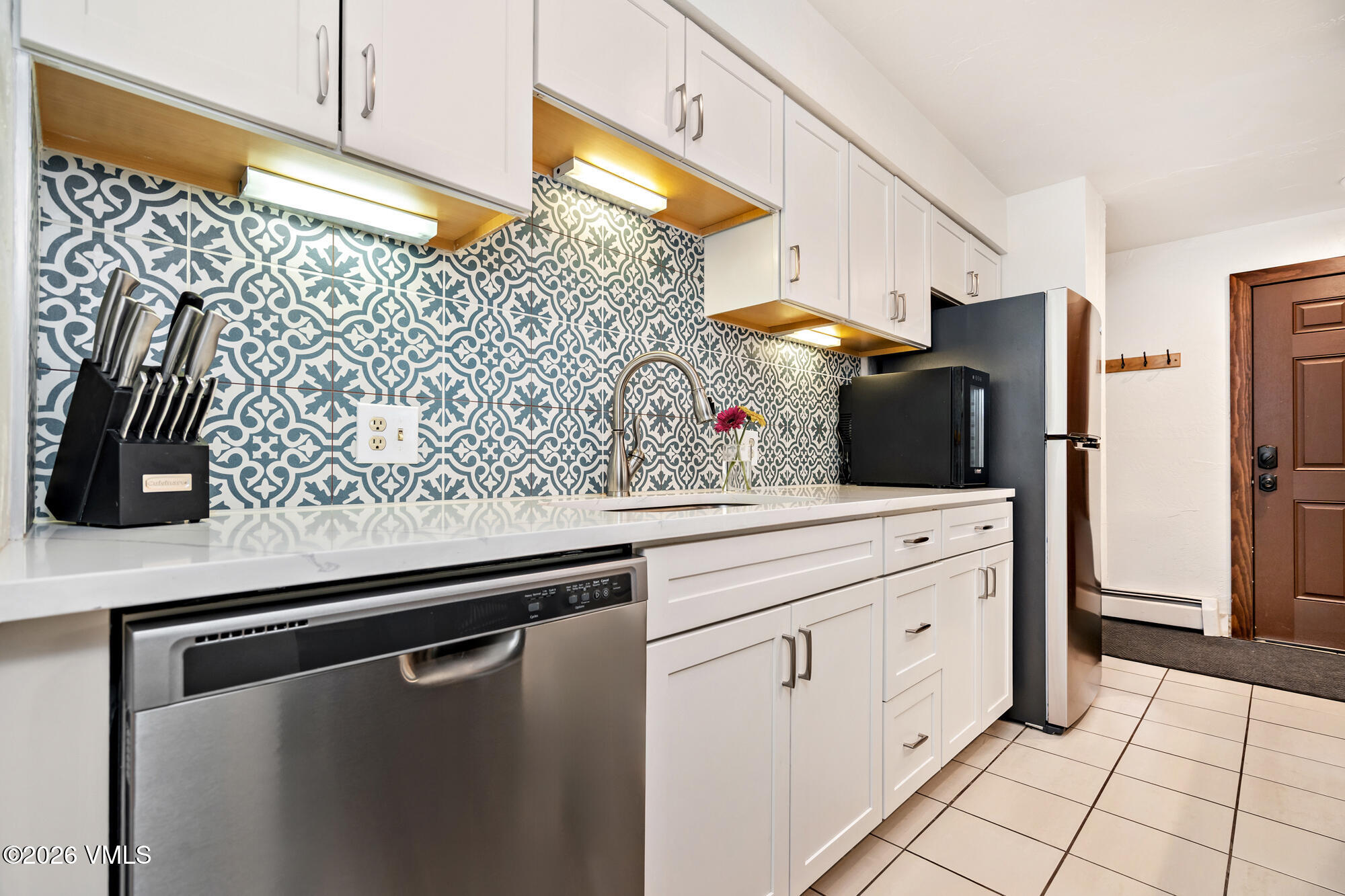 963 Lions Ridge Loop, Unit 502 Vail, CO 81657 - Photo 10 of 30 a kitchen with stainless steel appliances a refrigerator and cabinets