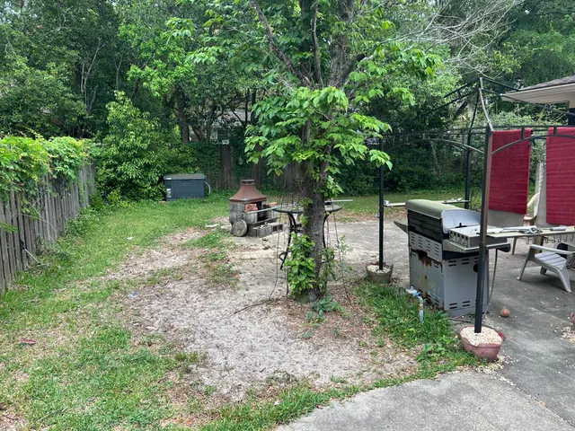 a view of a backyard with sitting area