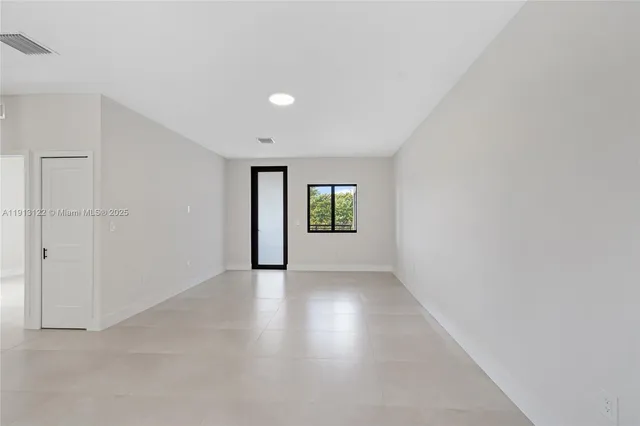 a view of a kitchen with a sink and dishwasher a stove top oven with white cabinets
