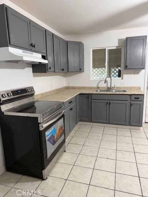 16100 Navajo Road Apple Valley, CA 92307 - Photo 44 of 55 a kitchen with stainless steel appliances granite countertop a stove a sink and a microwave