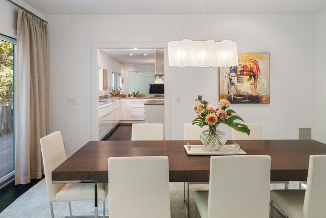 a view of a dining room with furniture and wooden floor