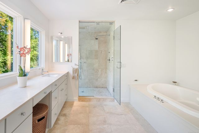 a bathroom with a granite countertop sink a toilet and shower
