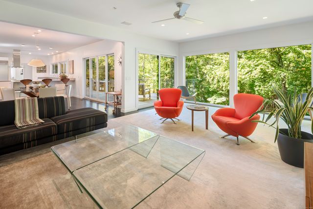 a living room filled with furniture and a large window