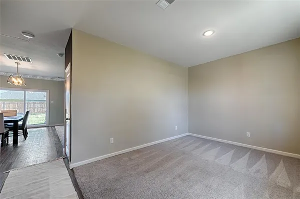 an empty room with furniture and a window