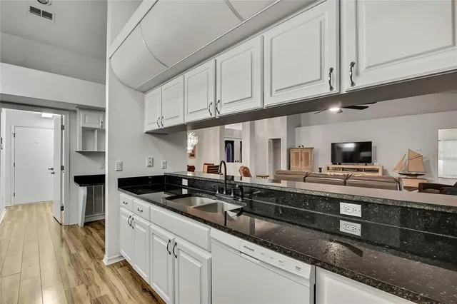 a bedroom with bed and wooden floor