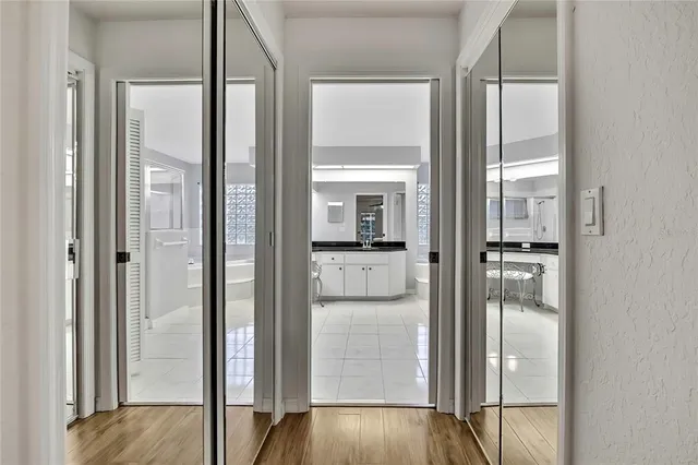 a kitchen with stainless steel appliances granite countertop white cabinets and a stove top oven
