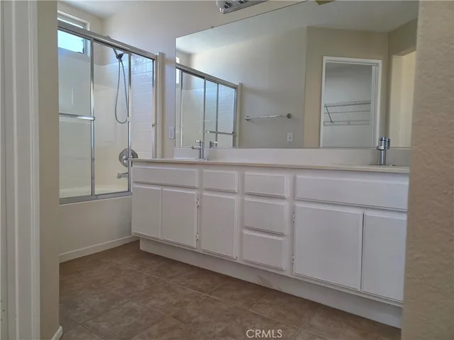 a spacious bathroom with a mirror sink and