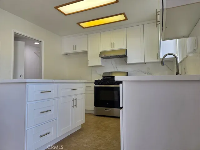 a kitchen with cabinets appliances and a sink