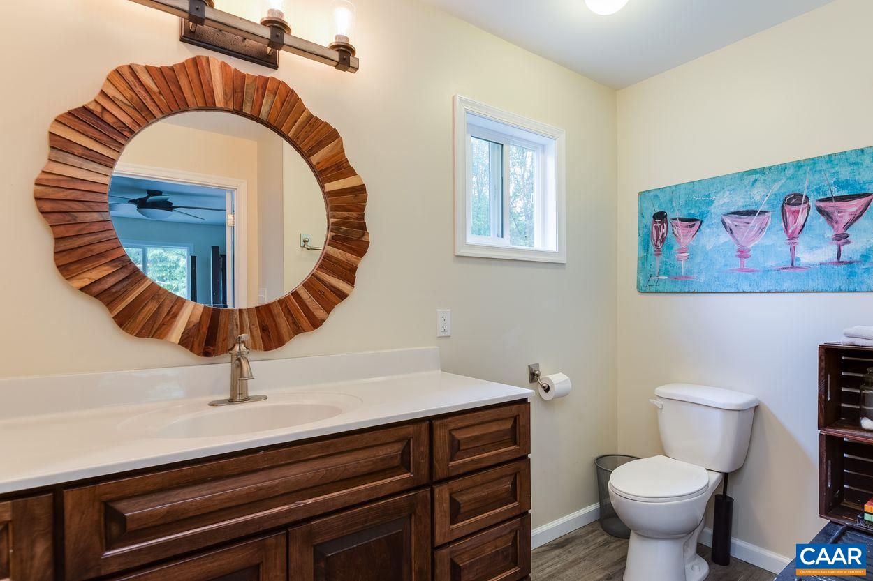 1612 Keith Valley Road Charlottesville, VA 22901 - Photo 16 of 30 a bathroom with a toilet a sink and a mirror