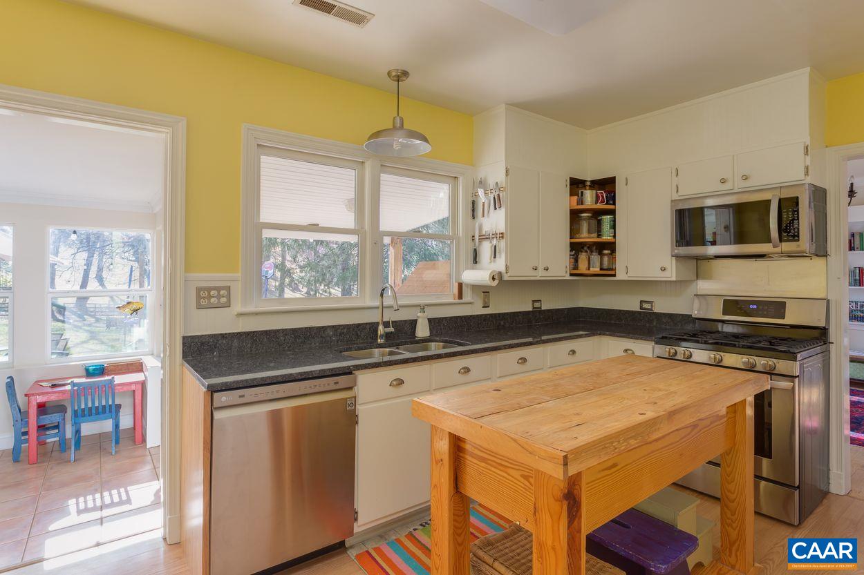 1612 Keith Valley Road Charlottesville, VA 22901 - Photo 6 of 30 a kitchen with stainless steel appliances a stove a sink and a microwave