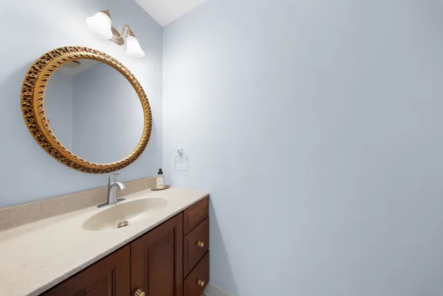 a bathroom with a sink mirror and vanity