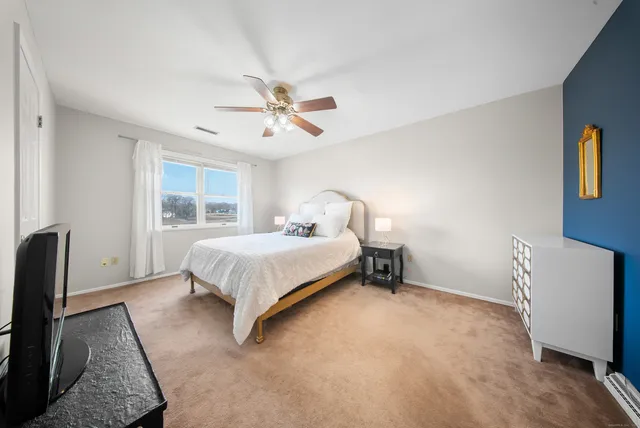 a bedroom with a bed and a window