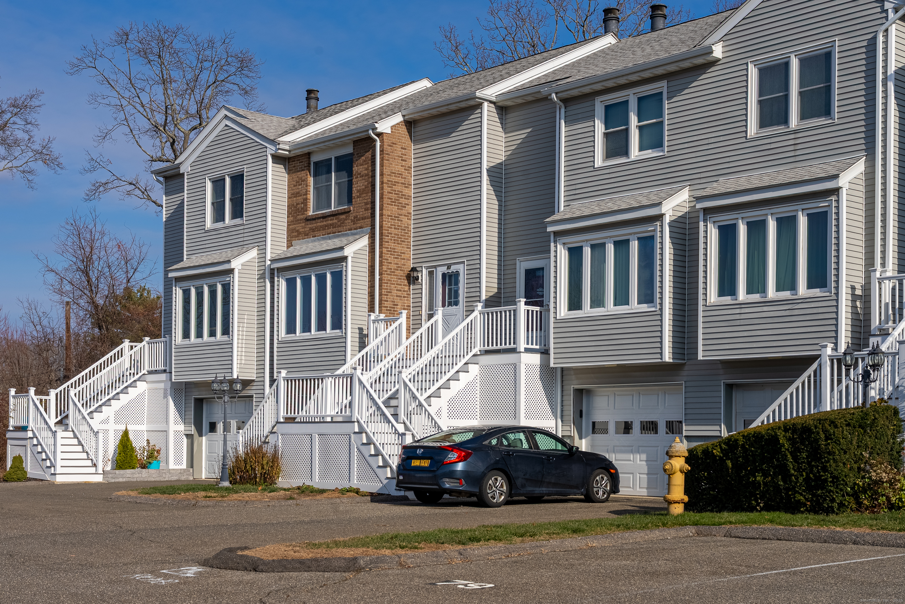 83 Carriage Drive, Unit 83 Milford, CT 06460 - Photo 2 of 33 a car parked in front of a building