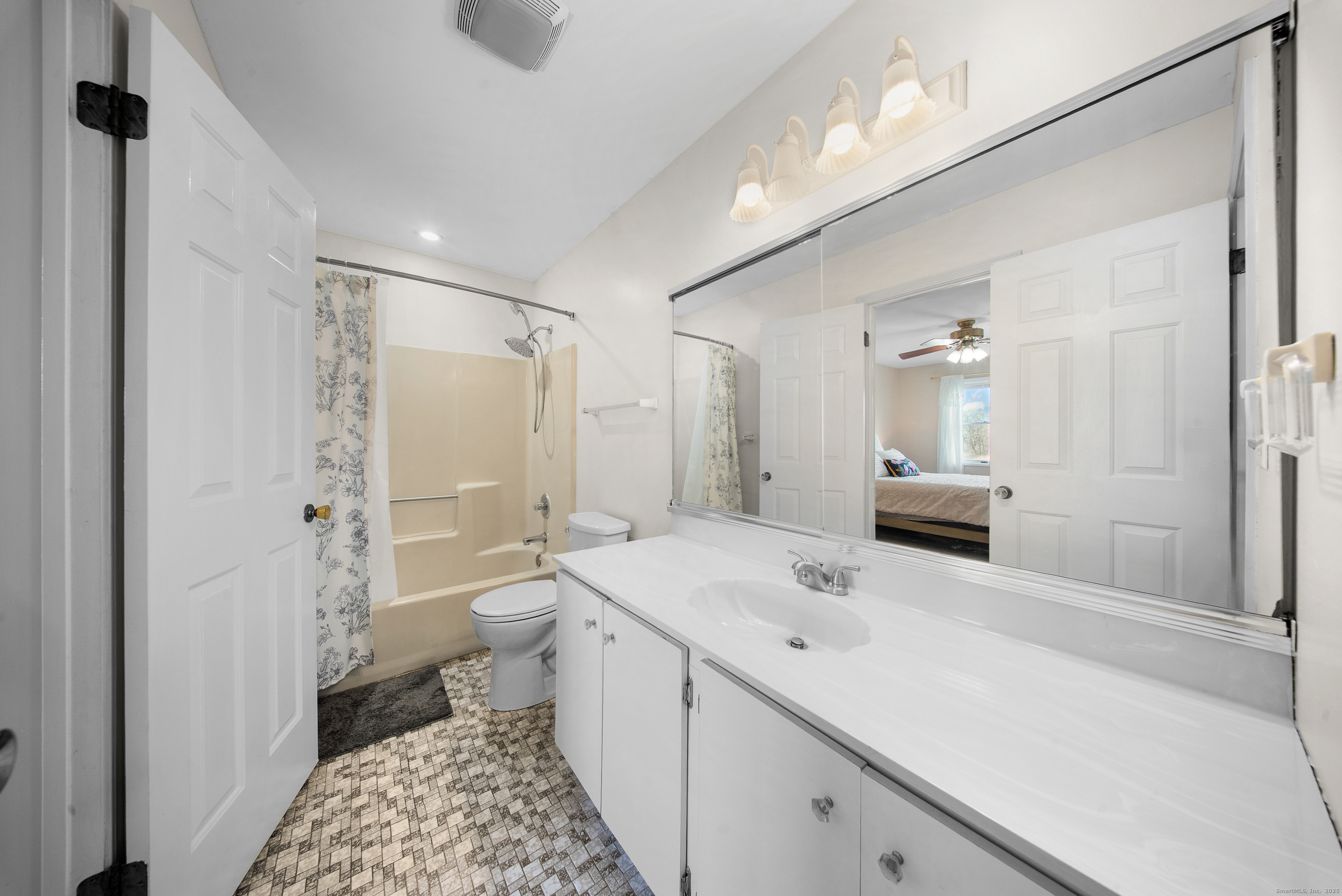 83 Carriage Drive, Unit 83 Milford, CT 06460 - Photo 21 of 33 a bathroom with a sink a toilet a shower and a mirror