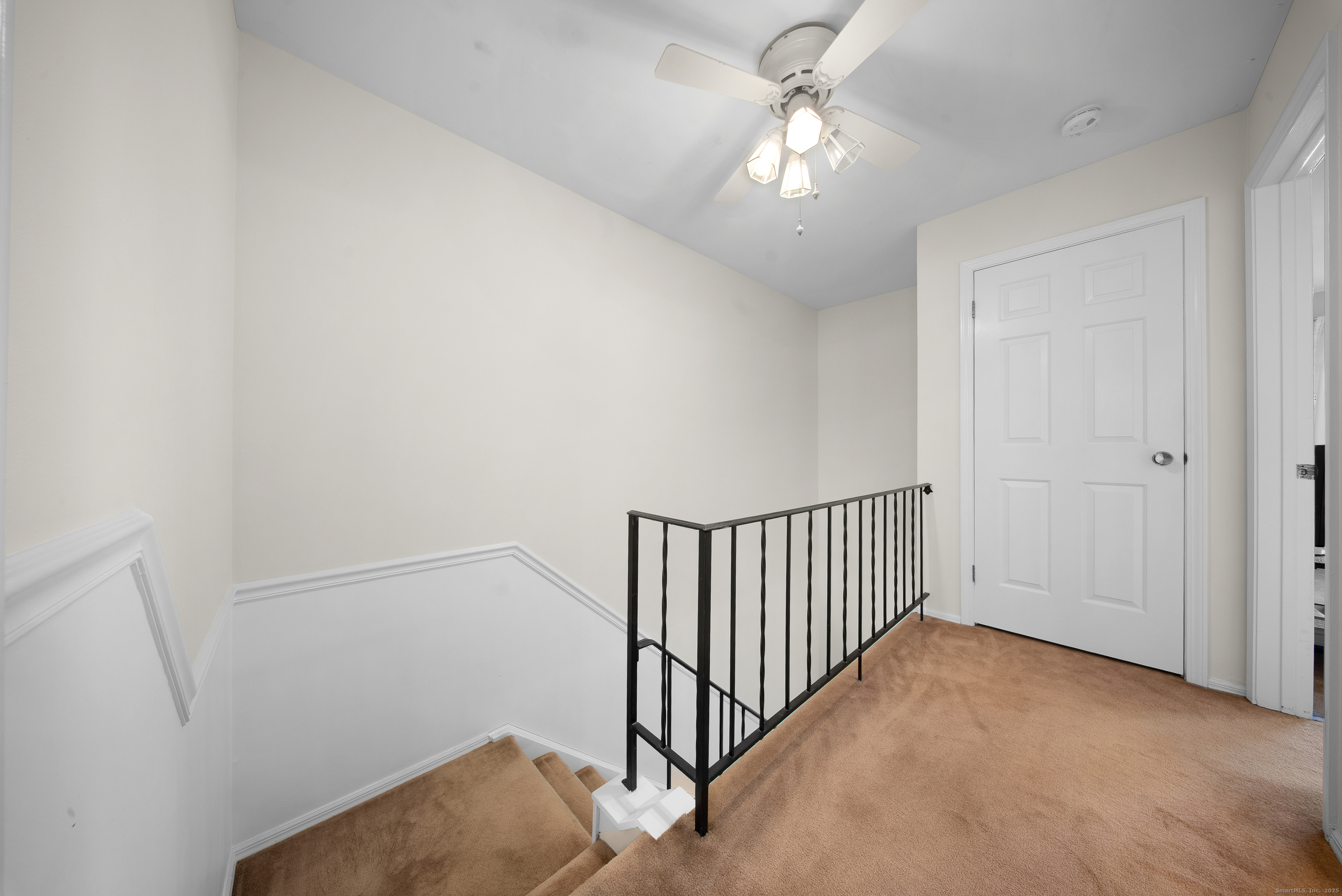 83 Carriage Drive, Unit 83 Milford, CT 06460 - Photo 22 of 33 a view of a hallway with a chandelier fan