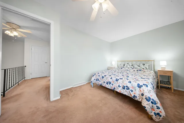 a bedroom with bed and a chandelier
